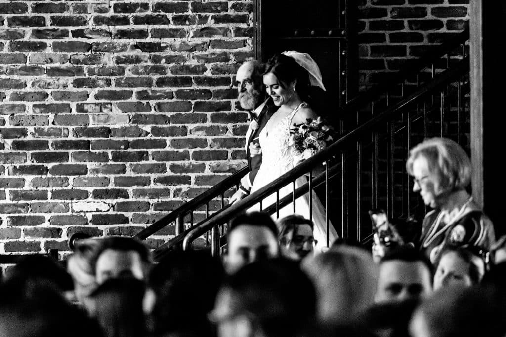 Bride walking down stairs Mile High Station Denver